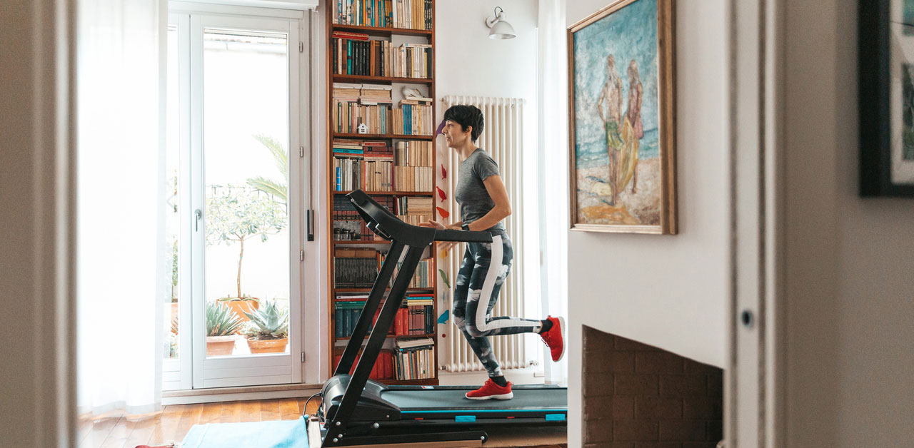 Woman running on a treadmill at home